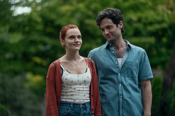 Madeline Brewer as Bronte and Penn Badgley as Joe standing next to each other in You Season 5