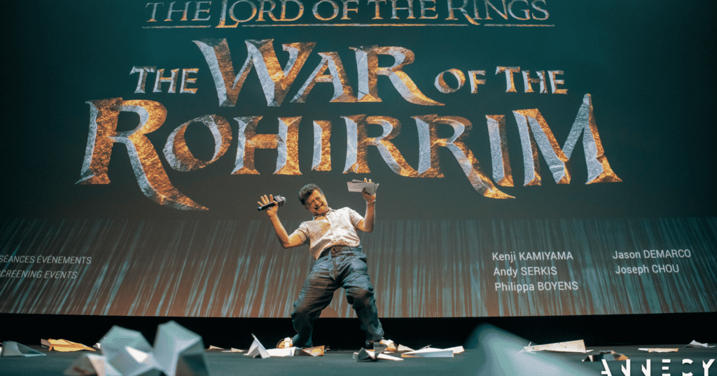 Andy Serkis on stage with Lord of the Rings: The War of the Rohirrim logo behind him