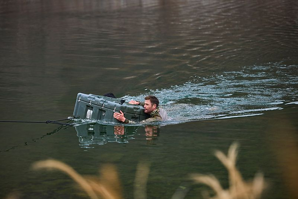 Chris Hemsworth clings to a floating box in water in 'Limitless: Live Better Now'