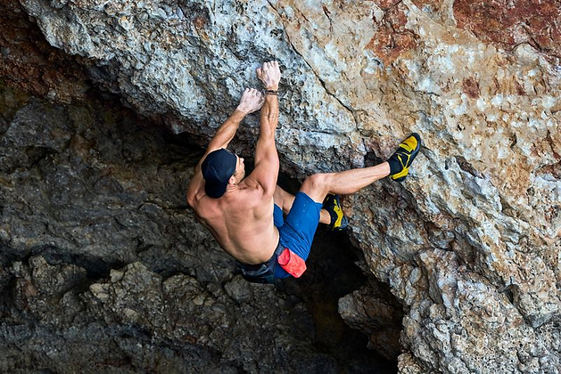 Chris Hemsworth free-climbing a rock wall in 'Limitless: Live Better Now'