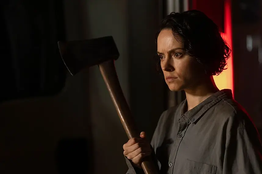 Daisy Ridley as Ava holding an axe in 'We Bury the Dead.'