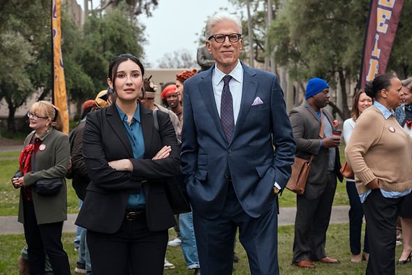 Lilah Richcreek Estrada as Julie and Ted Danson as Charles stand together with a crowd behind them at Wheeler College in 'A Man on the Inside' Season 2.