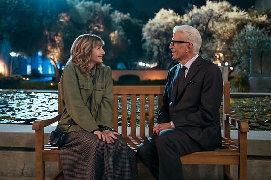 Mary Steenburgen as Mona and Ted Danson as Charles sit on a bench at night facing each other in 'A Man on the Inside' Season 2.