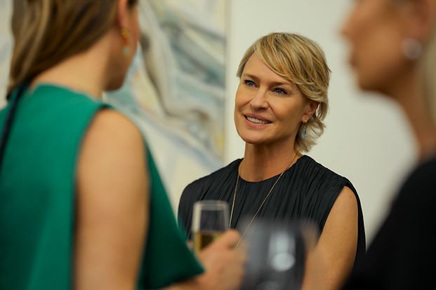 Robin Wright as Laura Sanderson at an art exhibition in 'The Girlfriend.'