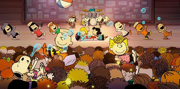 The Peanuts gang dances on a stage in front of an audience