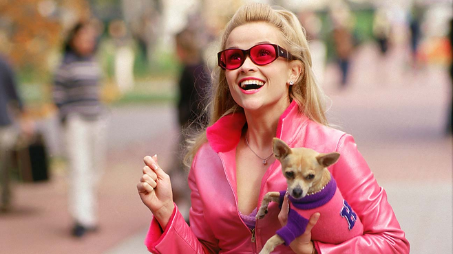 Reese Witherspoon as Elle Woods in 'Legally Blonde' dressed in all pink with a small dog
