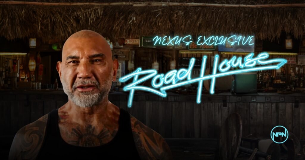 Dave Bautista looking at the camera. The ‘Road House’ logo is the right.