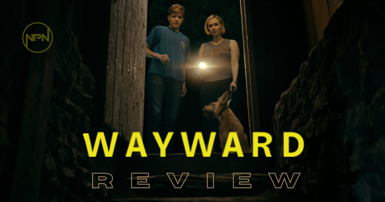 Wayward still with Mae Martin and Sarah Gadon looking down the stairs holding a flashlight
