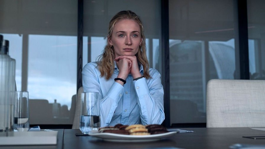 Sophie Turner as Zara Dunne sits in front of a plate of food and glass of water in 'Steal'