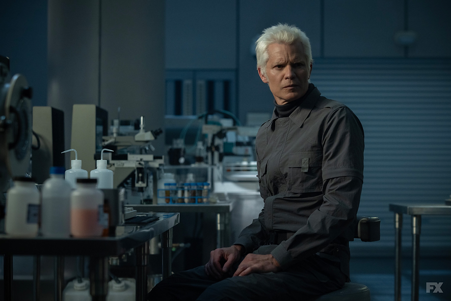 Timothy Olyphant sits at a lab table