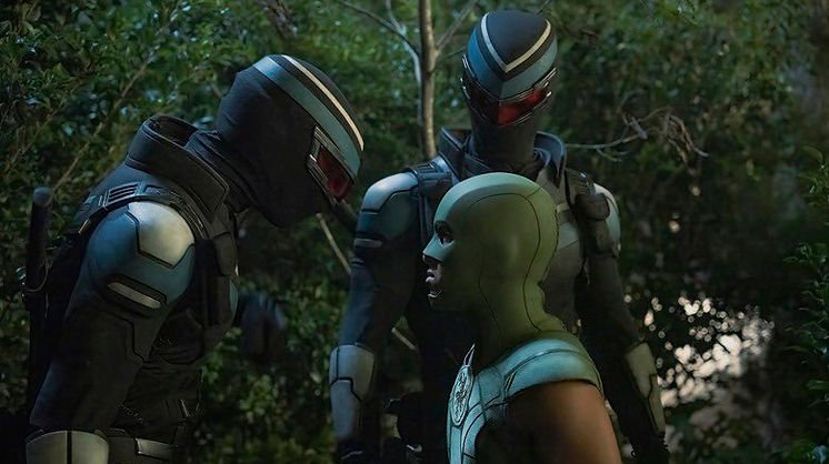 Freddie Stroma as Vigilante & Vigilante 2, and Nhut Le as Judomaster all stare each other down in 'Peacemaker' Season 2