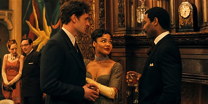 Hedda (Tessa Thompson) flanked by her husband (Tom Bateman) and Judge Brack (Nicholas Pinnock) have a conversation at a party in 'Hedda.'