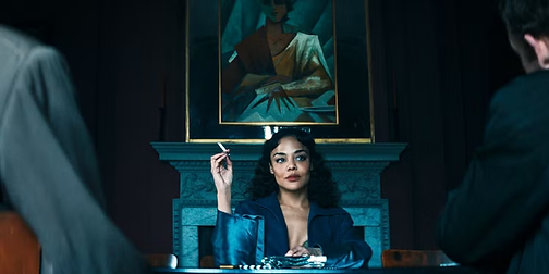 Hedda (Tessa Thompson) sits at a table while being interrogated in 'Hedda.'
