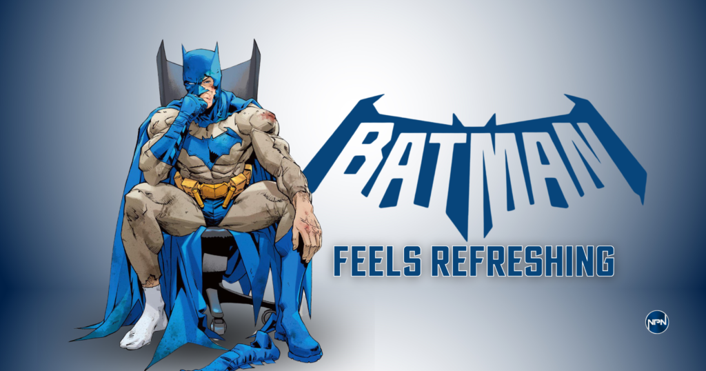 Batman with a tattered Batsuit sitting in an office chair.