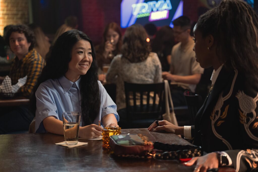Sherry Cola as Maya and Jessica Williams as Gaby facing each other while in conversation in Shrinking