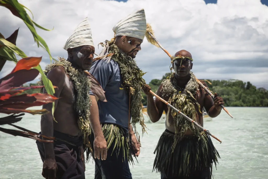 Will Smith accompanies indigenous island residents on a beach in Pole to Pole with Will Smith